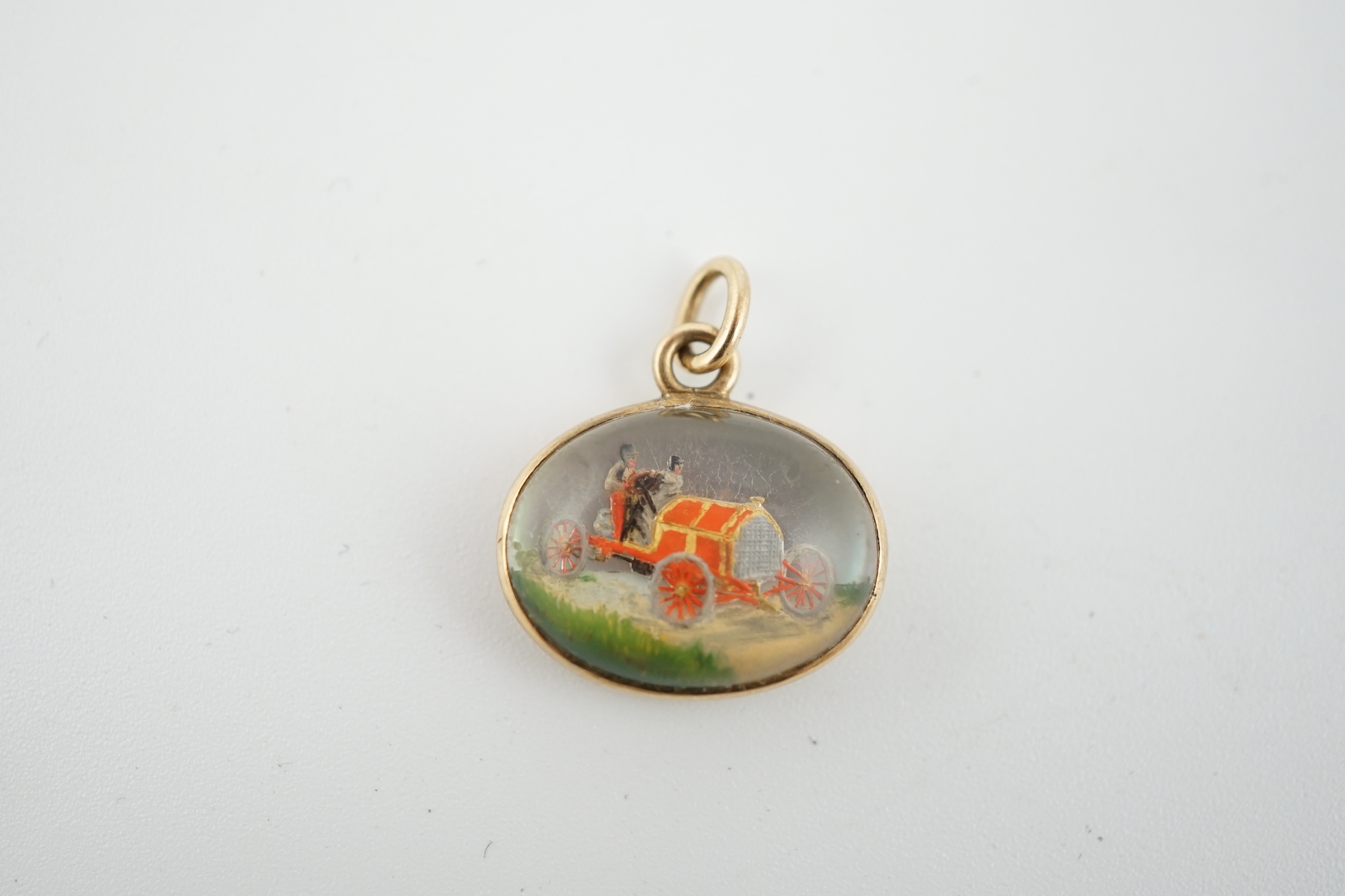 An Edwardian gold and Essex crystal oval fob pendant, commemorating the 1903 Paris-Madrid car race, organised by the Automobile Club de France